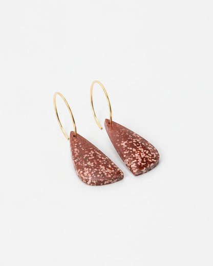 Elsita Jewelry Coral earrings featuring speckled terracotta-colored teardrop pendants on delicate gold hoops.