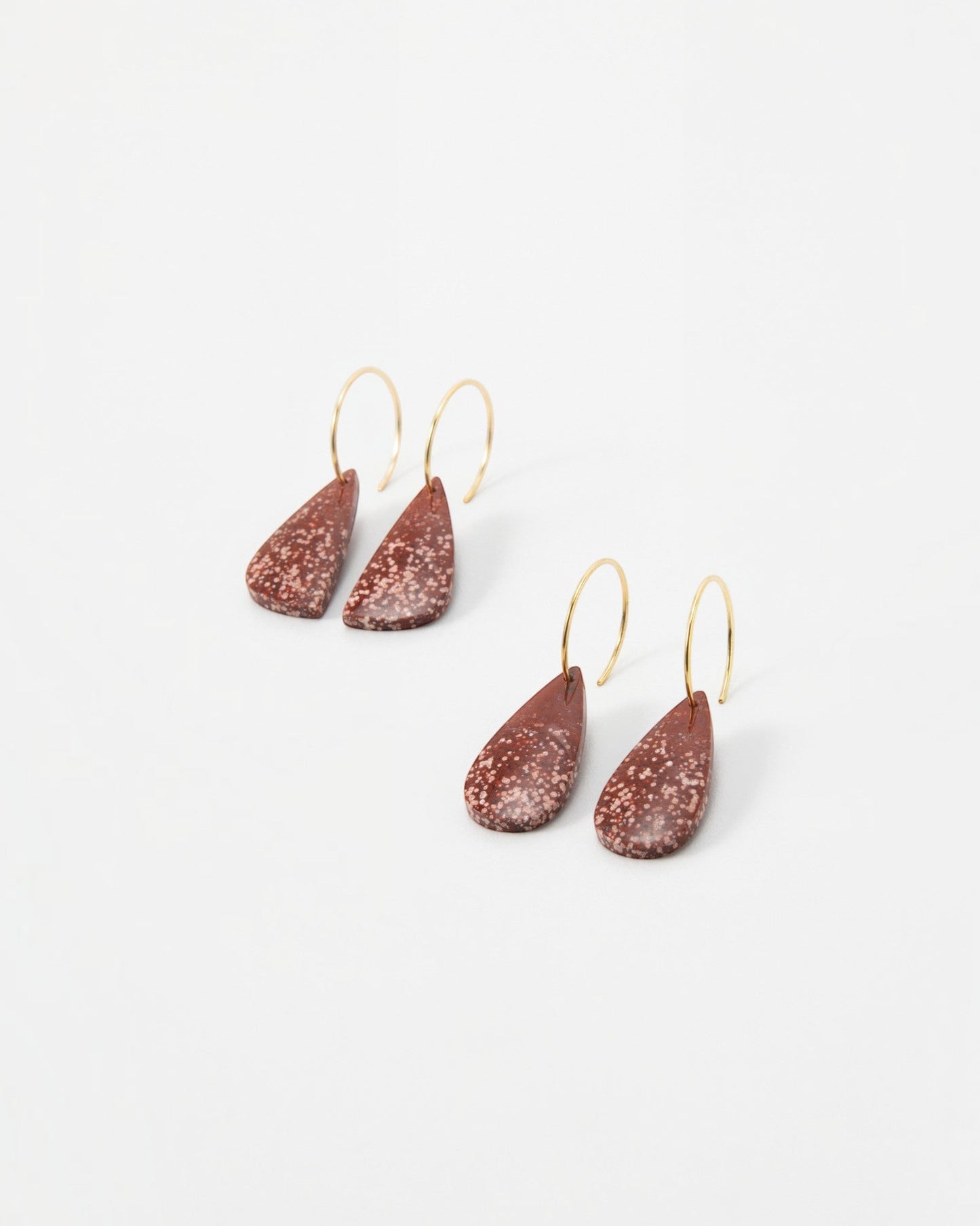 Elsita Jewelry Coral teardrop earrings featuring speckled terracotta clay pendants on delicate gold hoop wires.