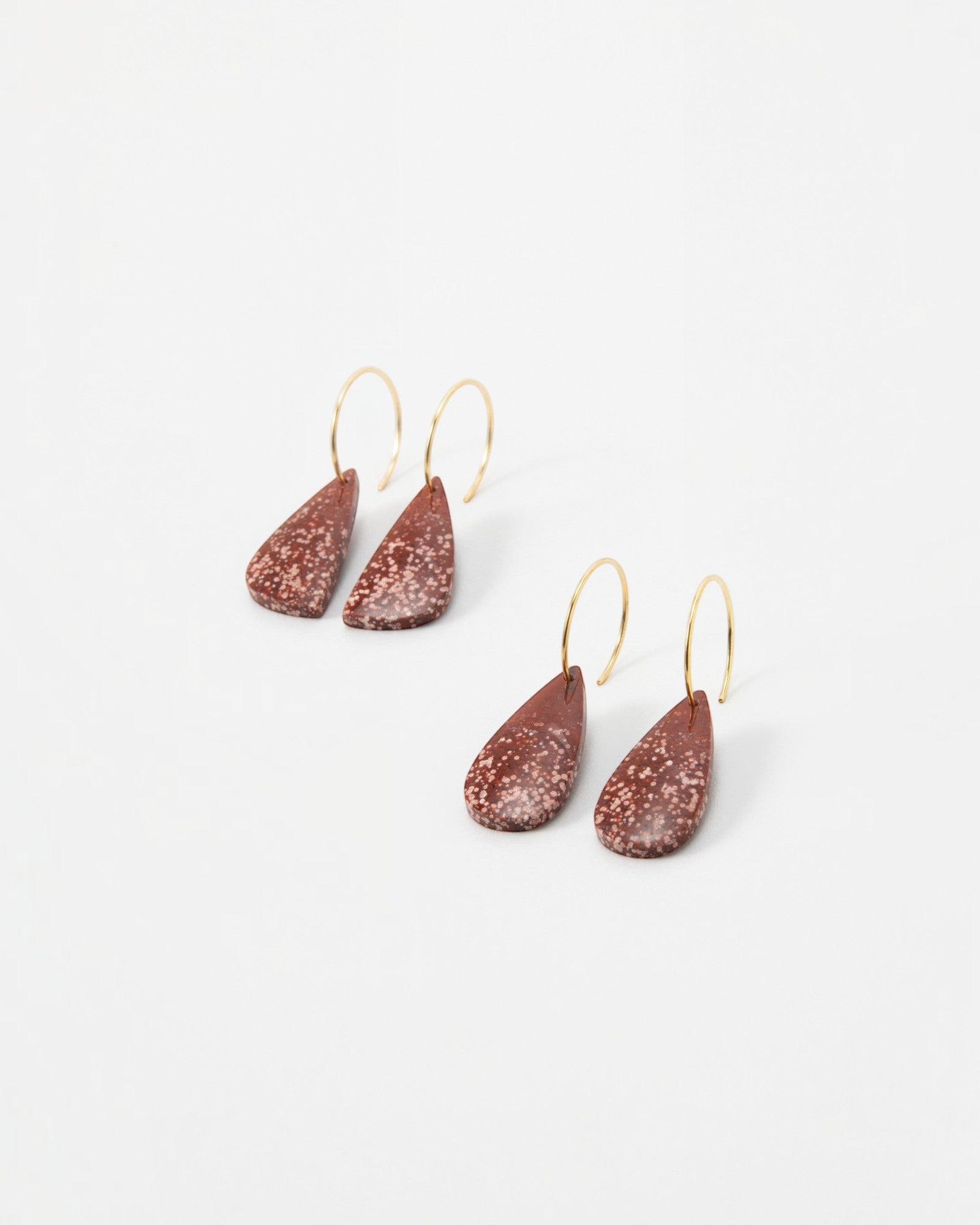 Elsita Jewelry Coral teardrop earrings featuring speckled terracotta clay pendants on delicate gold hoop wires.