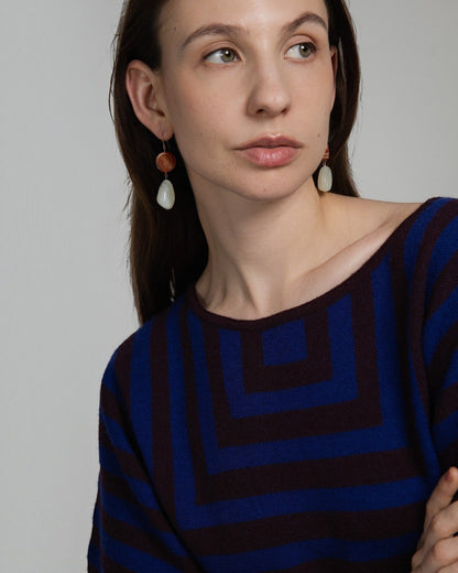 Model wearing Elsita Jewelry Dawn earrings featuring red banded agate and green Xiuyan jade on 14K gold-filled hooks.