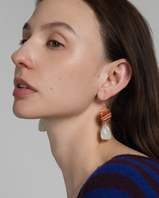 Model wearing Elsita Jewelry Dawn earrings featuring red banded agate and triangular Xiuyan jade on 14K gold-filled wire