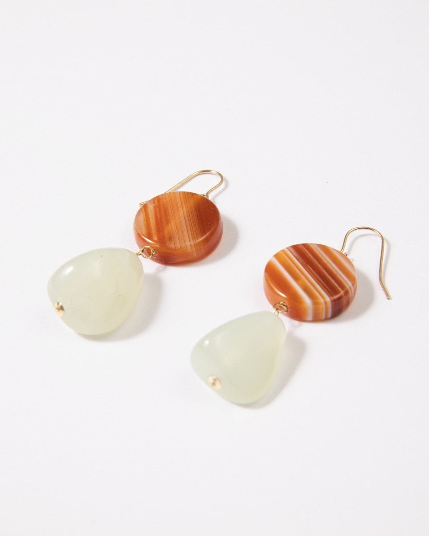 Elsita Jewelry Dawn earrings featuring round red banded agate and triangular green Xiuyan jade on 14K gold-filled hooks.