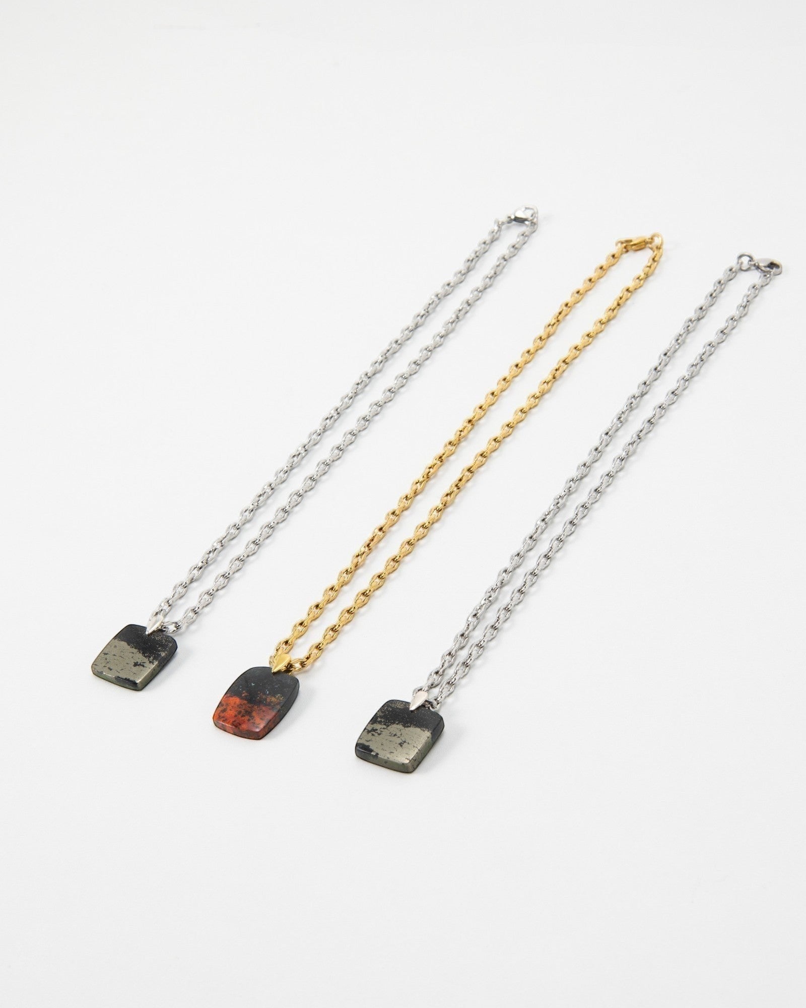 Elsita Jewelry Dune Day necklaces featuring square stone pendants on gold and silver link chains