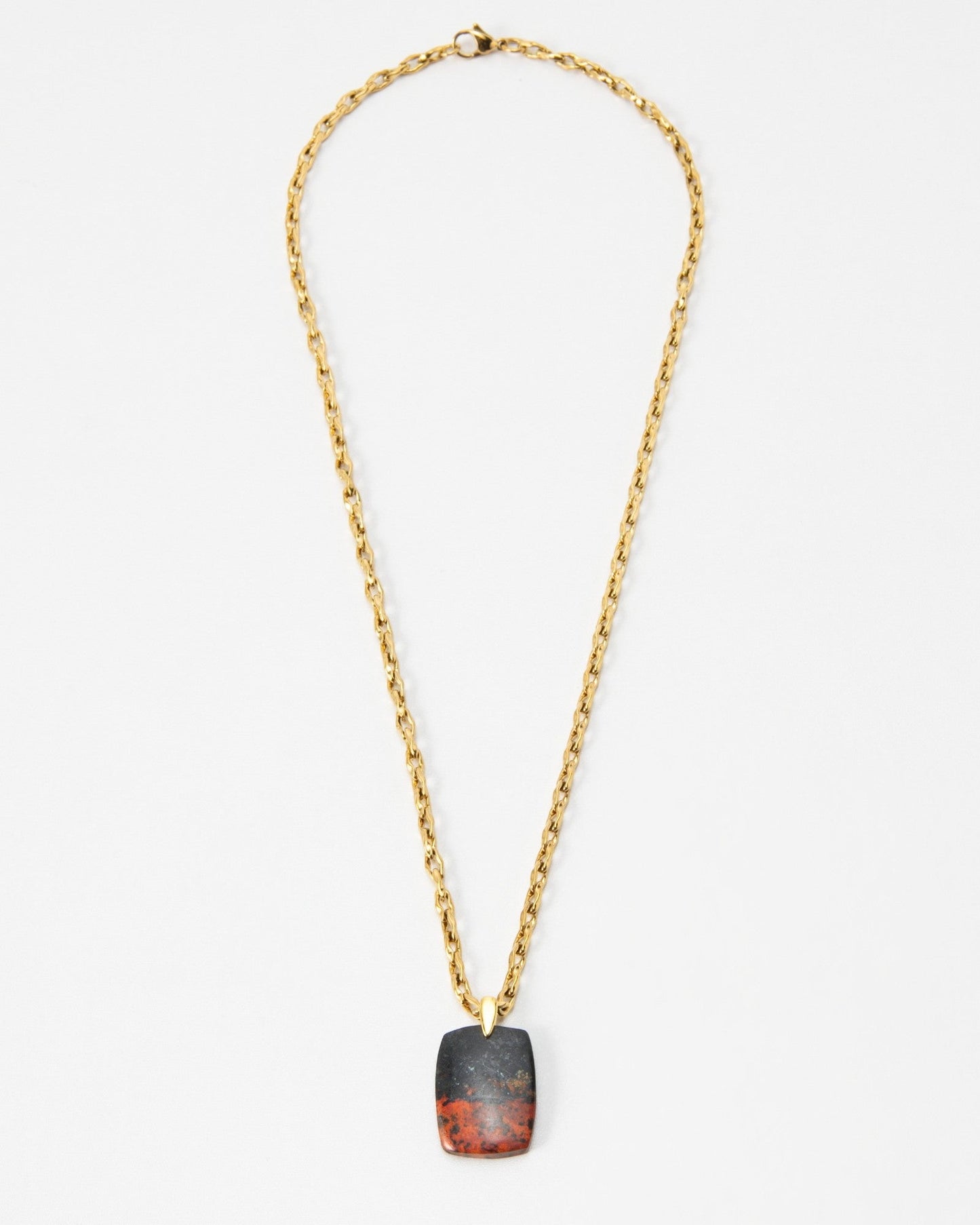 Elsita Jewelry Dune Day necklace featuring a rectangular stone pendant with black and red tones on a gold chain