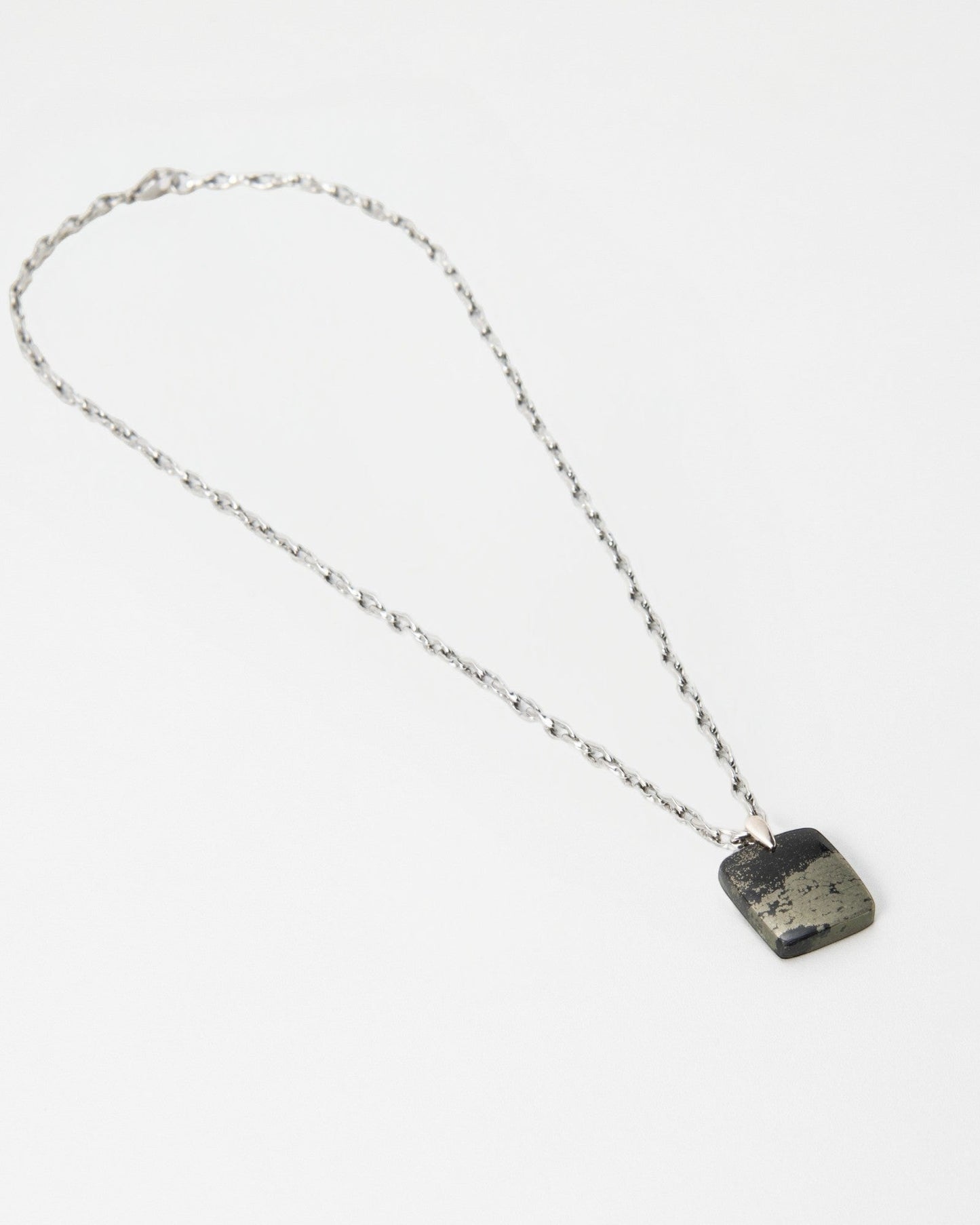 Elsita Jewelry Dune Night necklace featuring a square metallic pyrite pendant on a delicate silver chain