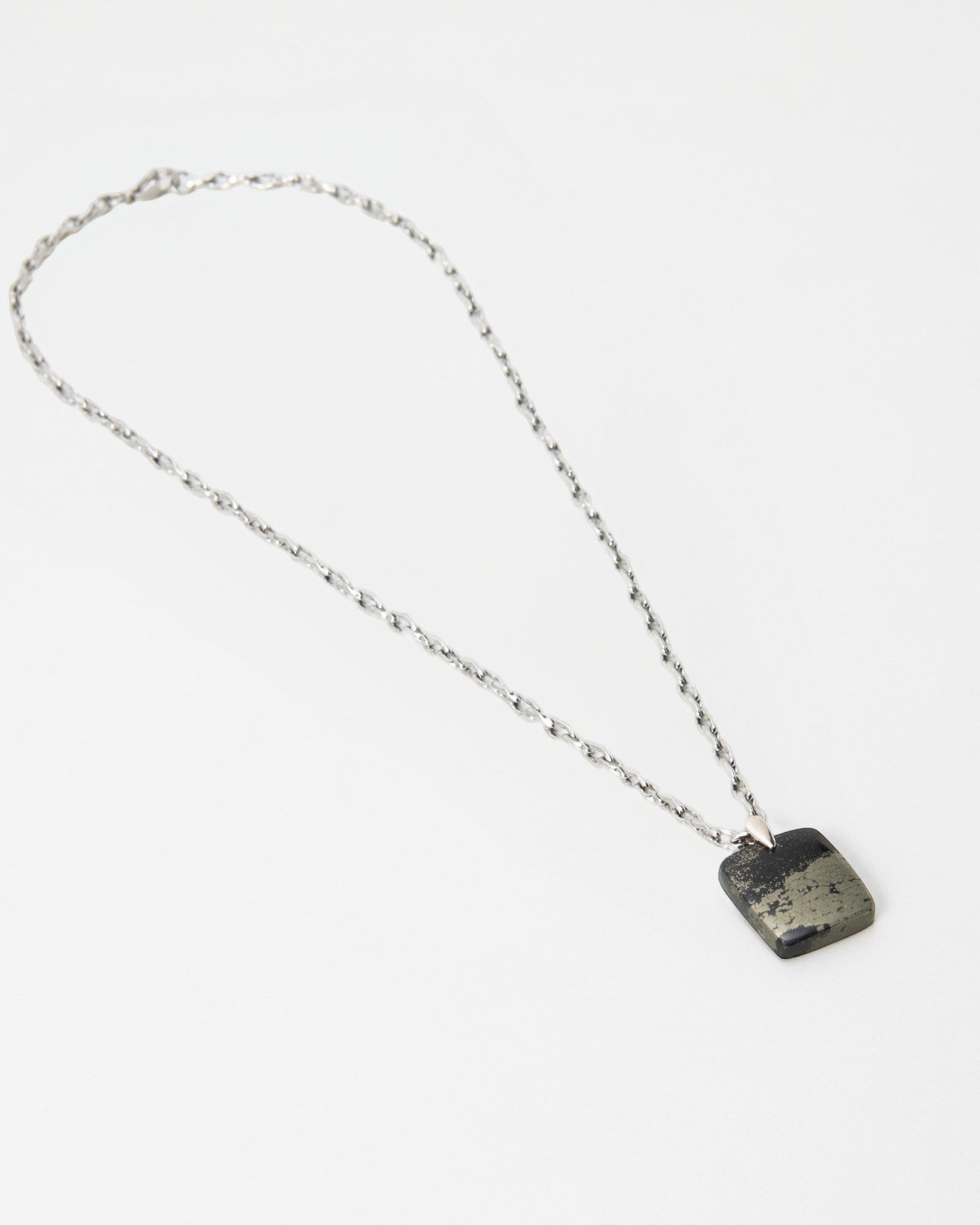 Elsita Jewelry Dune Night necklace featuring a square metallic pyrite pendant on a delicate silver chain