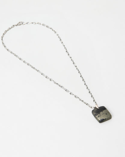 Elsita Jewelry Dune Night necklace featuring a square metallic pyrite pendant on a delicate silver chain