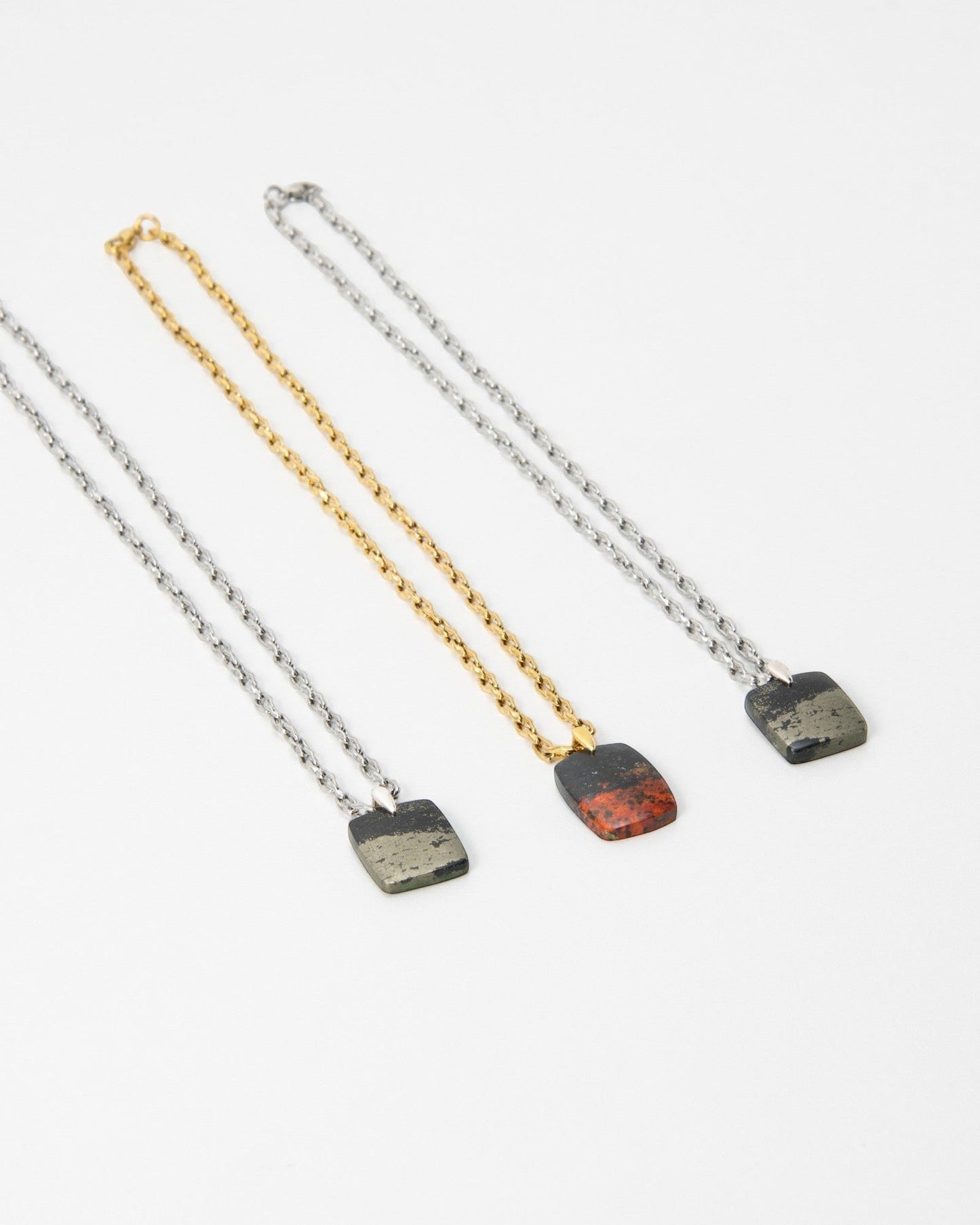 Elsita Jewelry Dune Night necklaces featuring three square stone pendants on gold and silver chains.