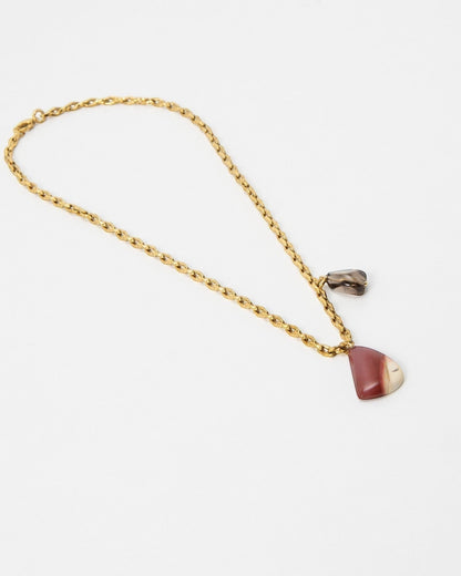 Elsita Jewelry Ember necklace featuring a gold chain with a polished red and cream stone pendant and small charm
