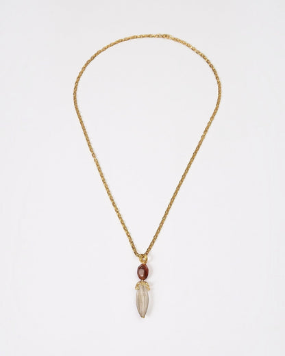Elsita Jewelry Flame necklace featuring a raw clear quartz pendant and red agate on a textured gold chain.
