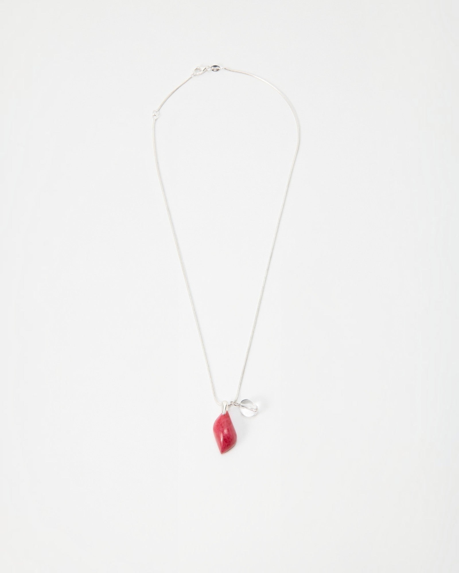 Elsita Jewelry Fuchsia necklace featuring a small red organic-shaped pendant and silver charm on a delicate chain