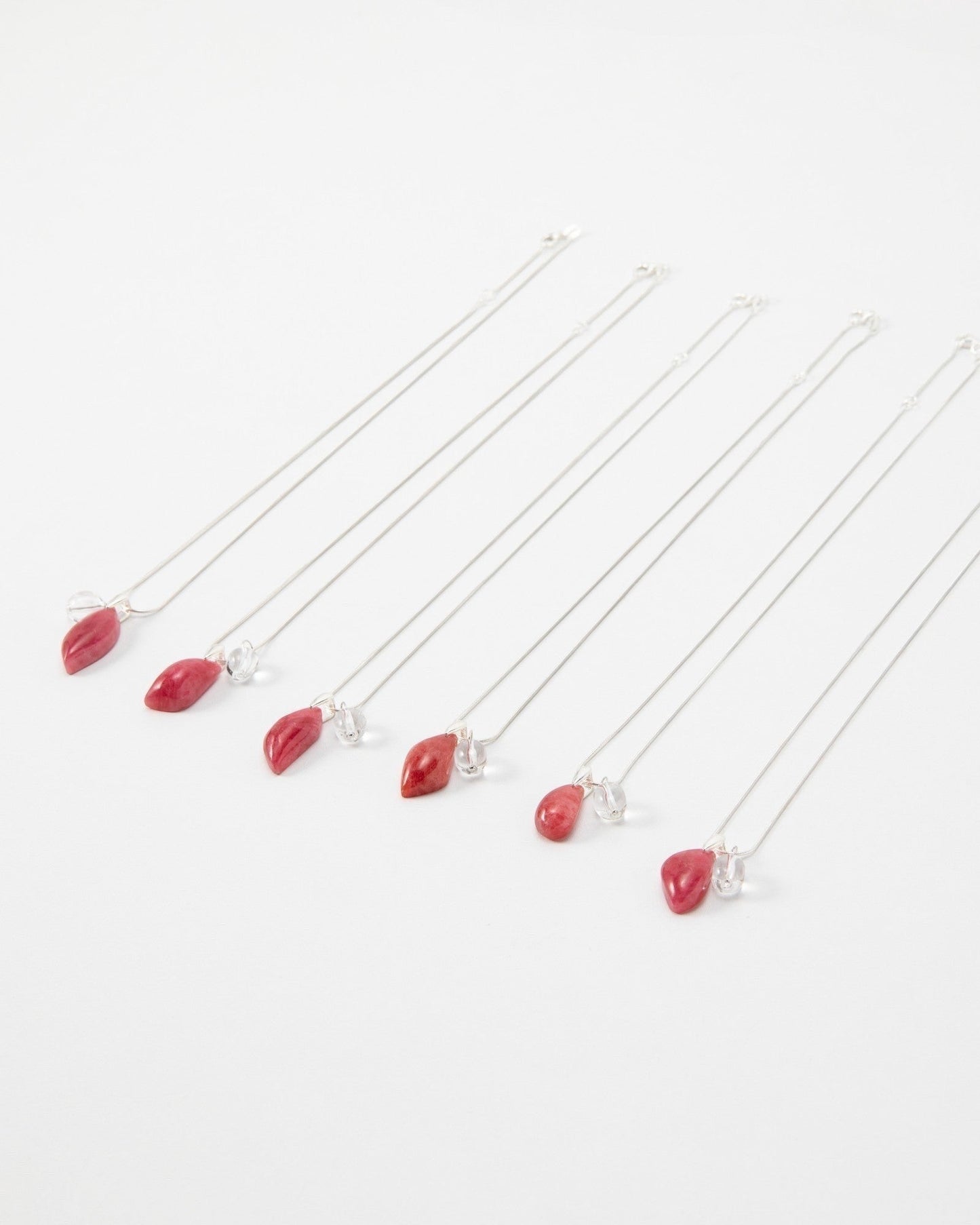 Elsita Jewelry Fuchsia necklaces featuring small red teardrop pendants on delicate silver chains