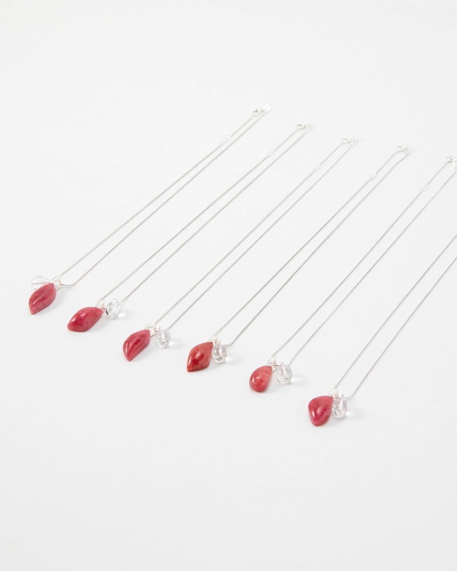Elsita Jewelry Fuchsia necklaces featuring small red teardrop pendants on delicate silver chains
