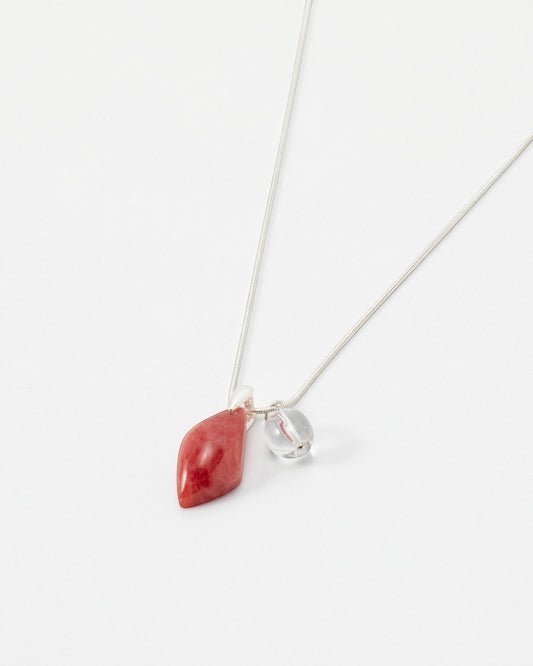 Elsita Jewelry Fuchsia necklace featuring a teardrop-shaped red stone and a small clear bead on a delicate silver chain.