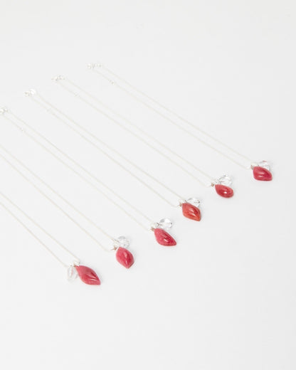 Elsita Jewelry Fuchsia necklaces featuring delicate silver chains with small red teardrop pendants on white background