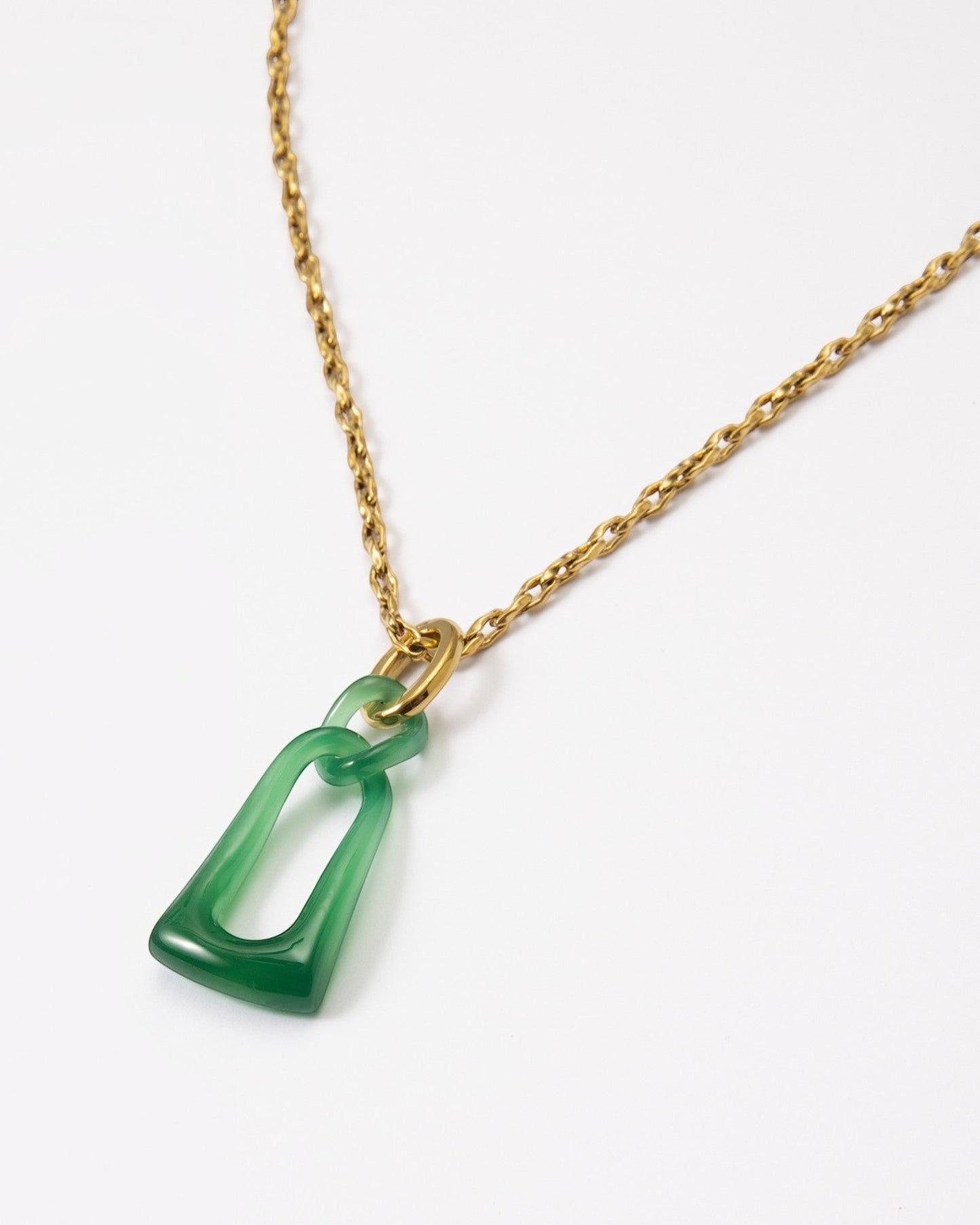 Elsita Jewelry Link Green necklace featuring a hand-carved green agate pendant with two interlocked loops on a gold chain