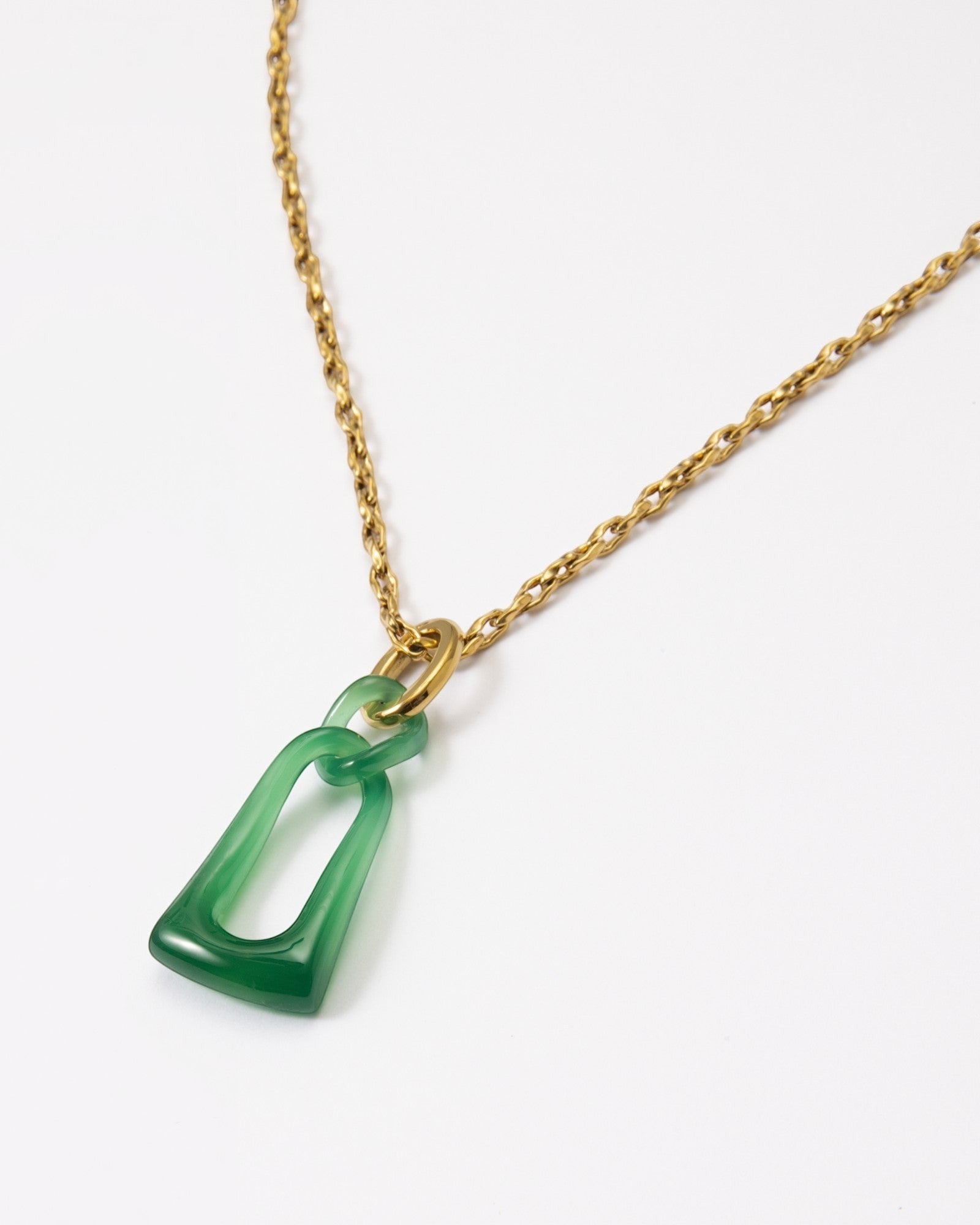 Elsita Jewelry Link Green necklace featuring a hand-carved green agate pendant with two interlocked loops on a gold chain