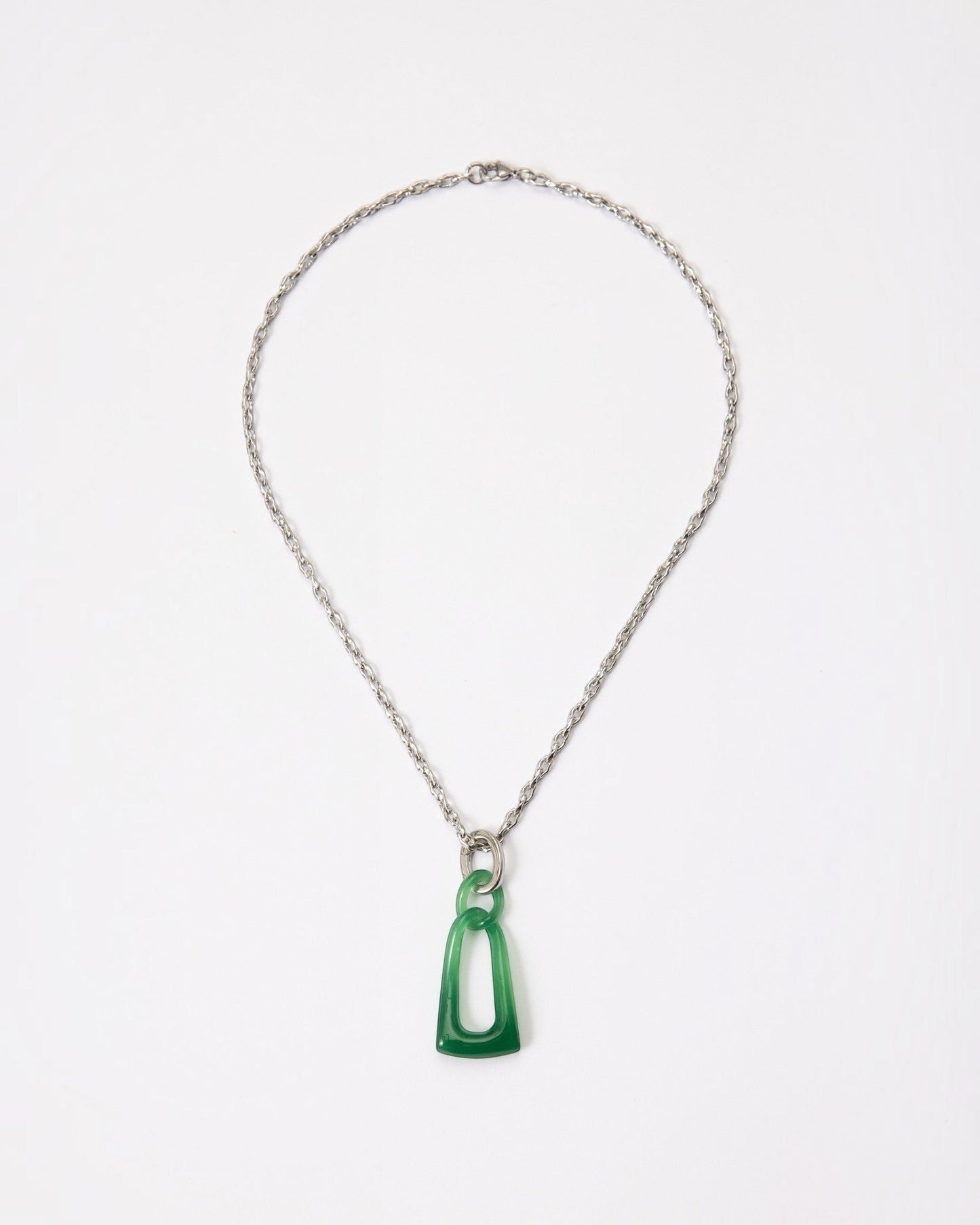 Elsita Jewelry Link Green necklace featuring a hand-carved green agate interlocked chain pendant on a silver chain.