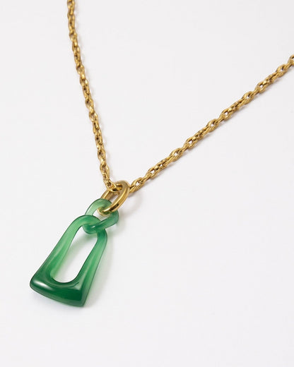 Elsita Jewelry Link Green necklace featuring a hand-carved green agate interlocked chain pendant on a gold-tone chain.
