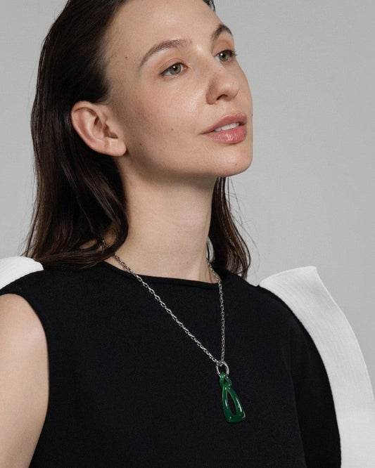 Model wearing an Elsita Jewelry green agate pendant necklace featuring two interlocked hand-carved stone chain links.