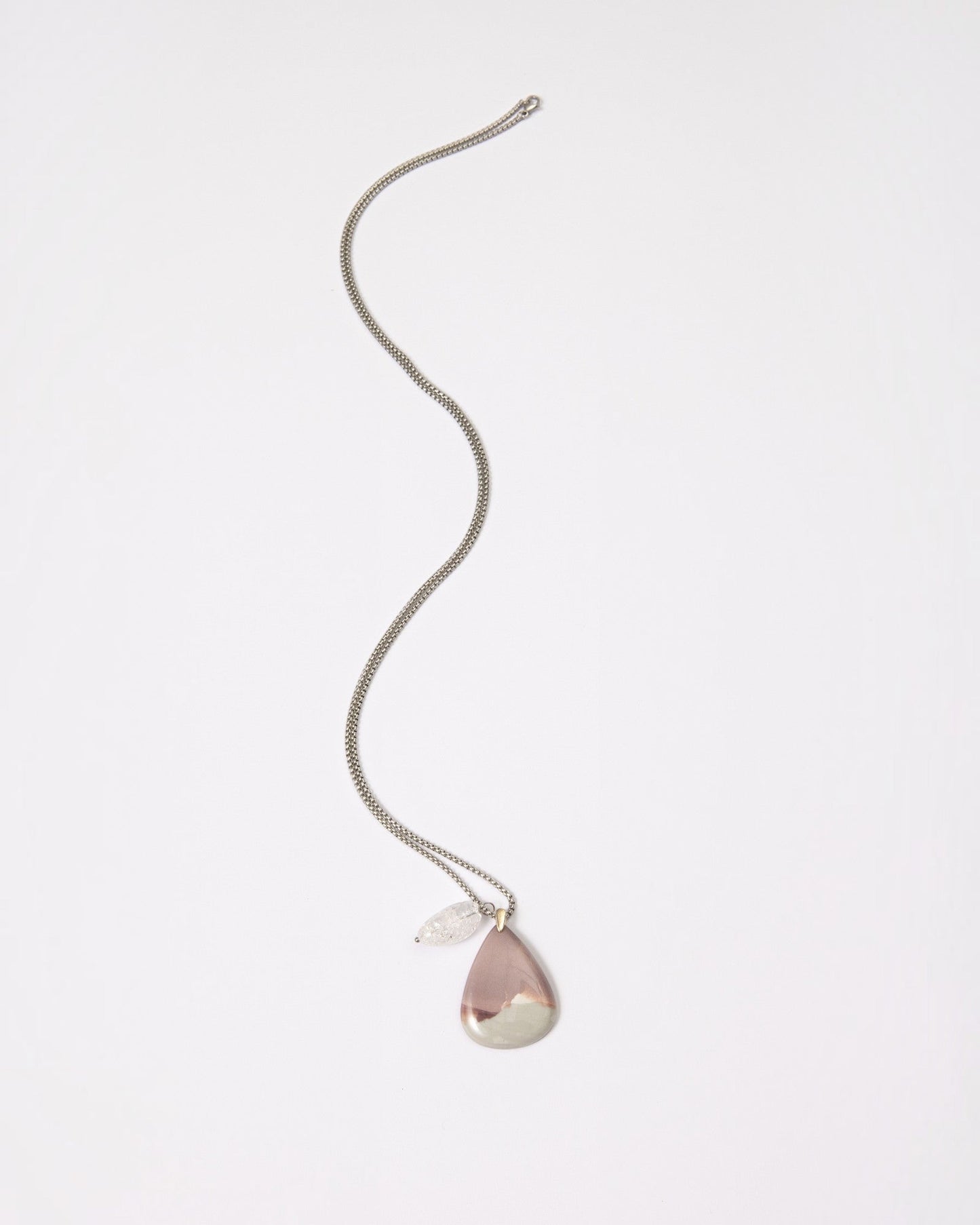 Elsita Jewelry Mauve V necklace featuring a teardrop Hyacinth Jasper pendant and clear quartz on a silver chain.