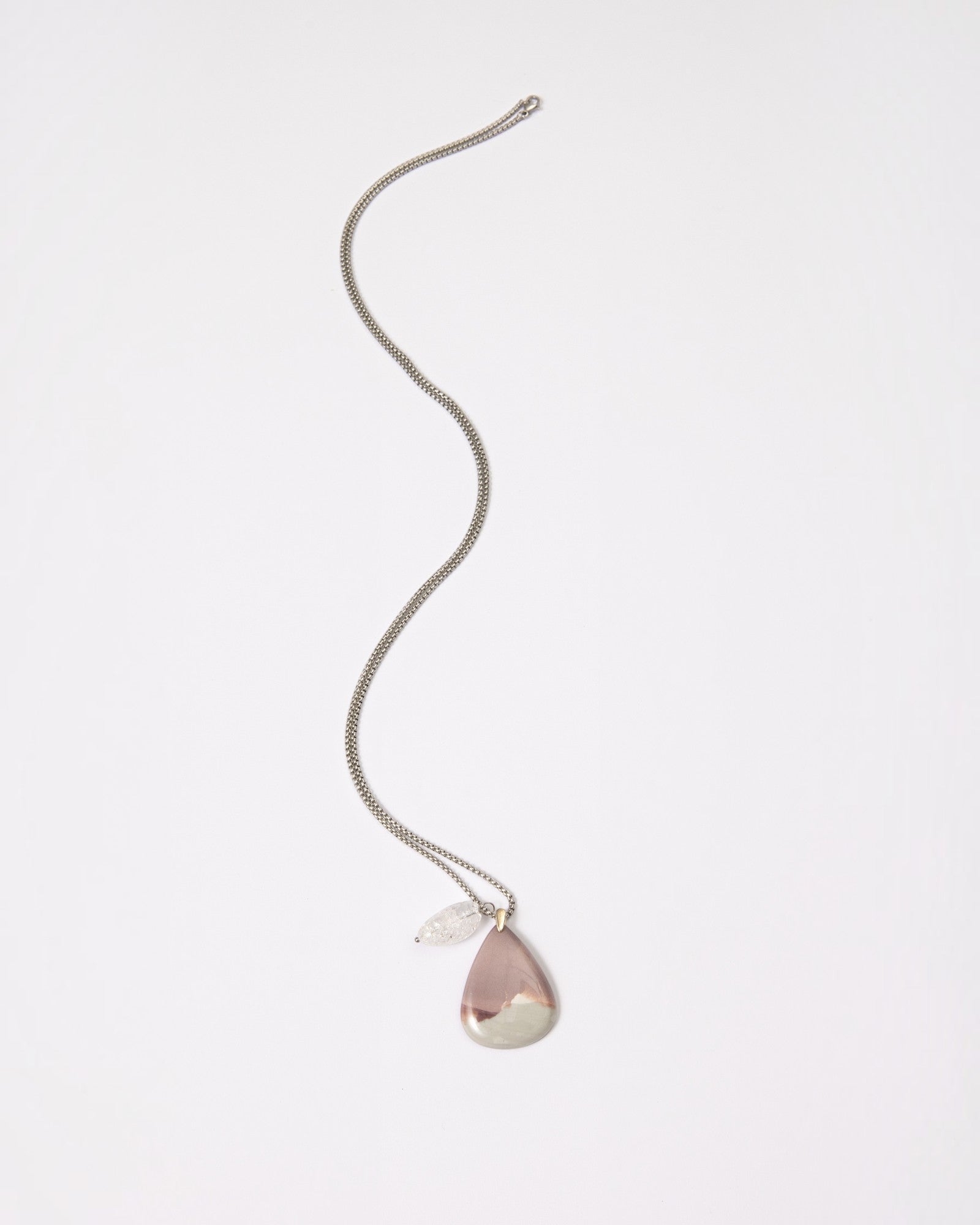 Elsita Jewelry Mauve V necklace featuring a teardrop Hyacinth Jasper pendant and clear quartz on a silver chain.