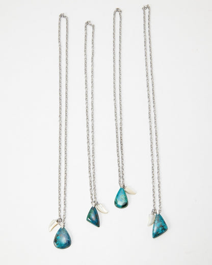 Elsita Jewelry Lagoon II necklaces featuring teardrop-shaped blue stone pendants and small white accents on silver chains
