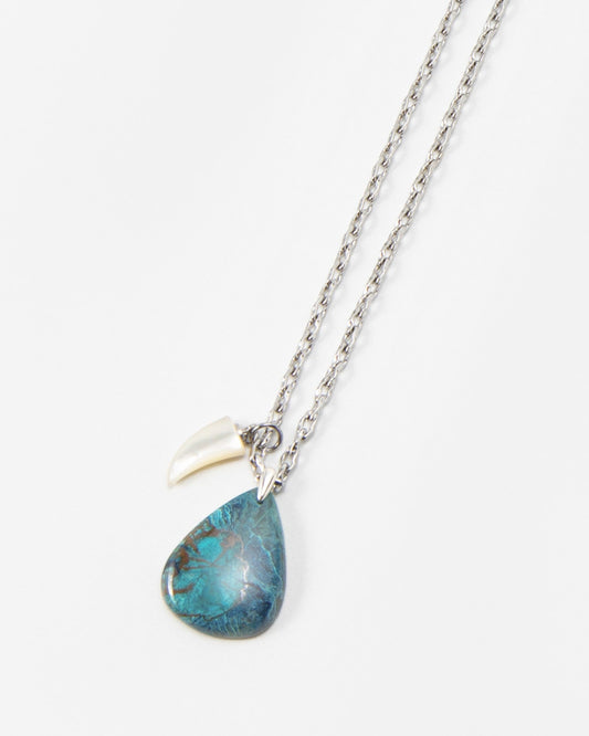 Elsita Jewelry Lagoon II necklace featuring a teardrop-shaped blue stone pendant and a small white charm on a silver chain