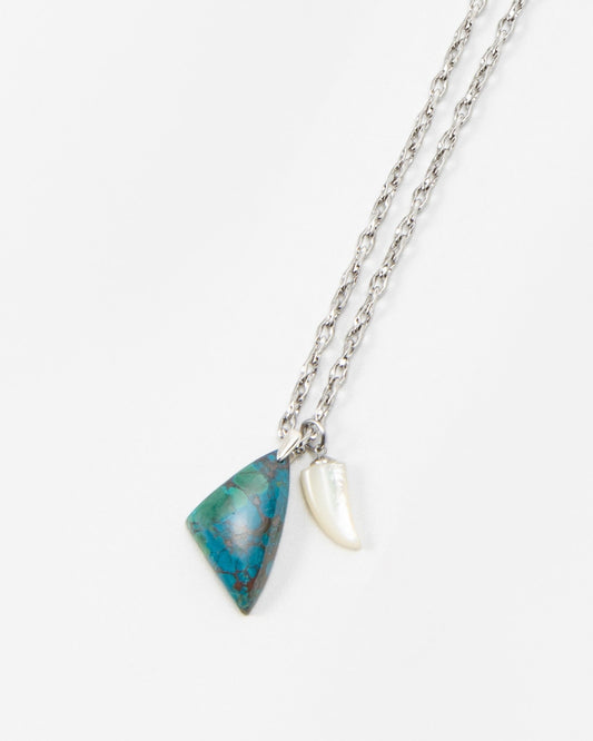 Elsita Jewelry Lagoon III necklace featuring a silver chain with a blue triangular stone pendant and a white shell charm