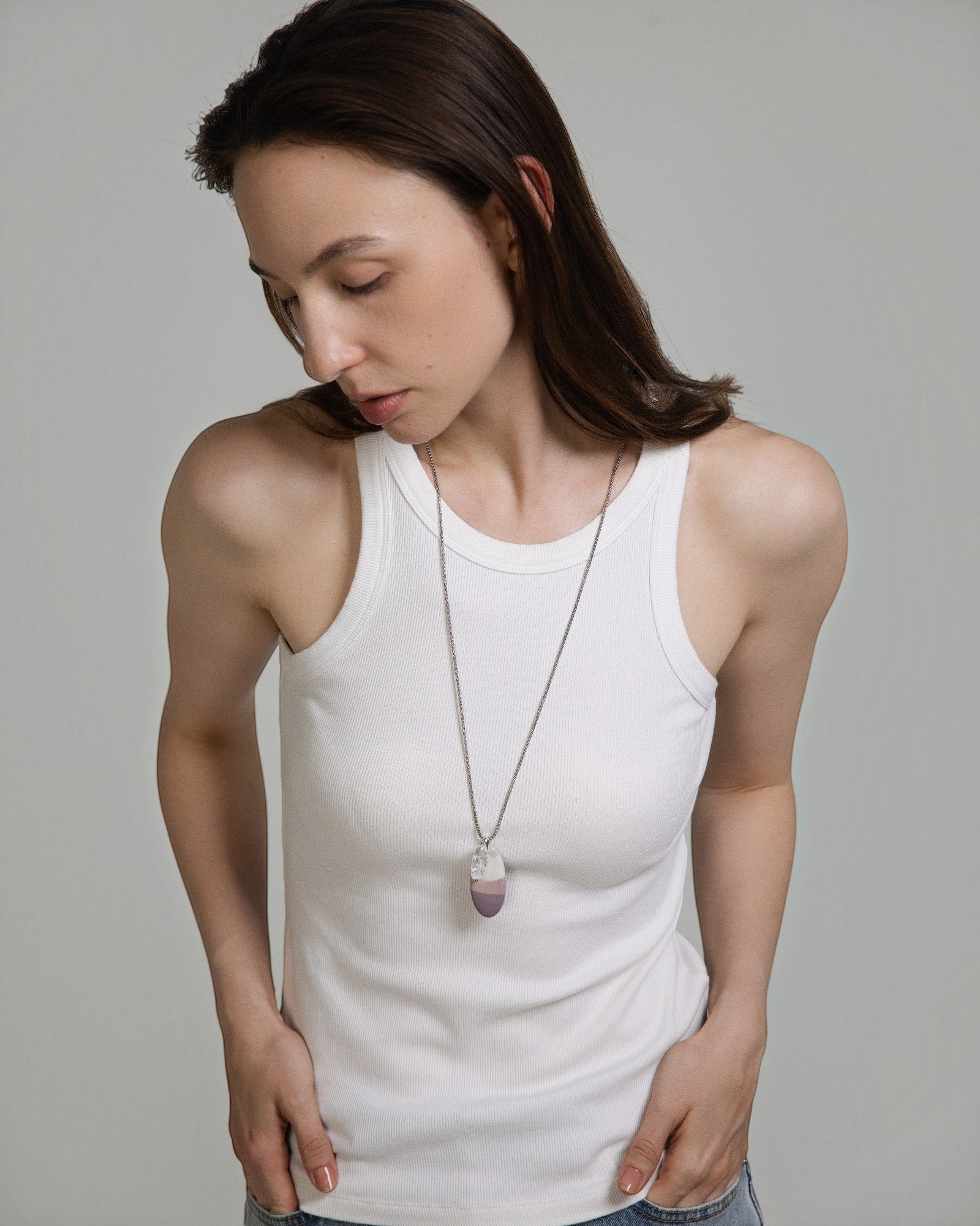 Elsita Jewelry Mauve II necklace featuring a Hyacinth Jasper and clear quartz pendant on a stainless steel chain.