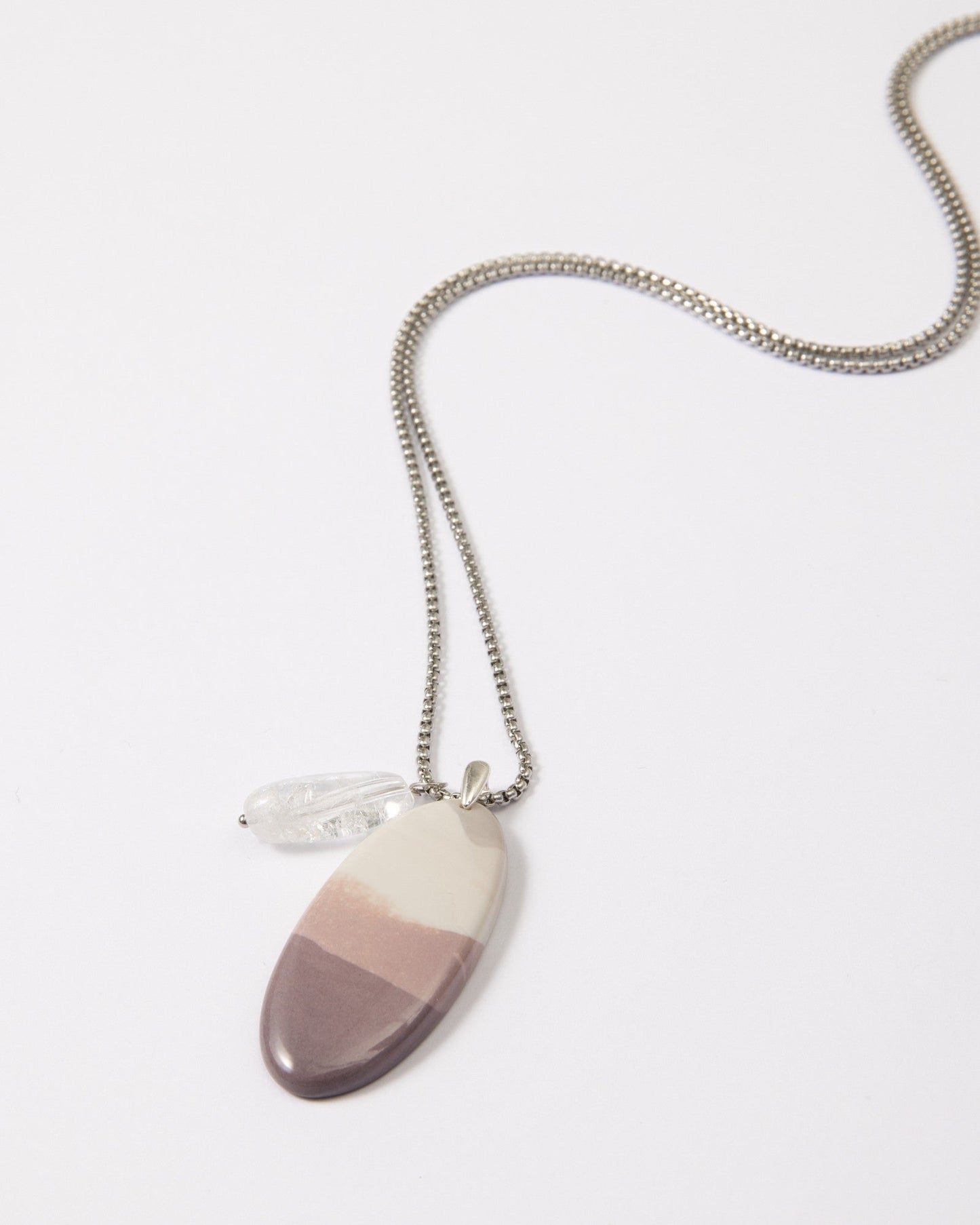 Elsita Jewelry Mauve I necklace featuring a gradient Hyacinth Jasper pendant and clear quartz on a stainless steel chain.
