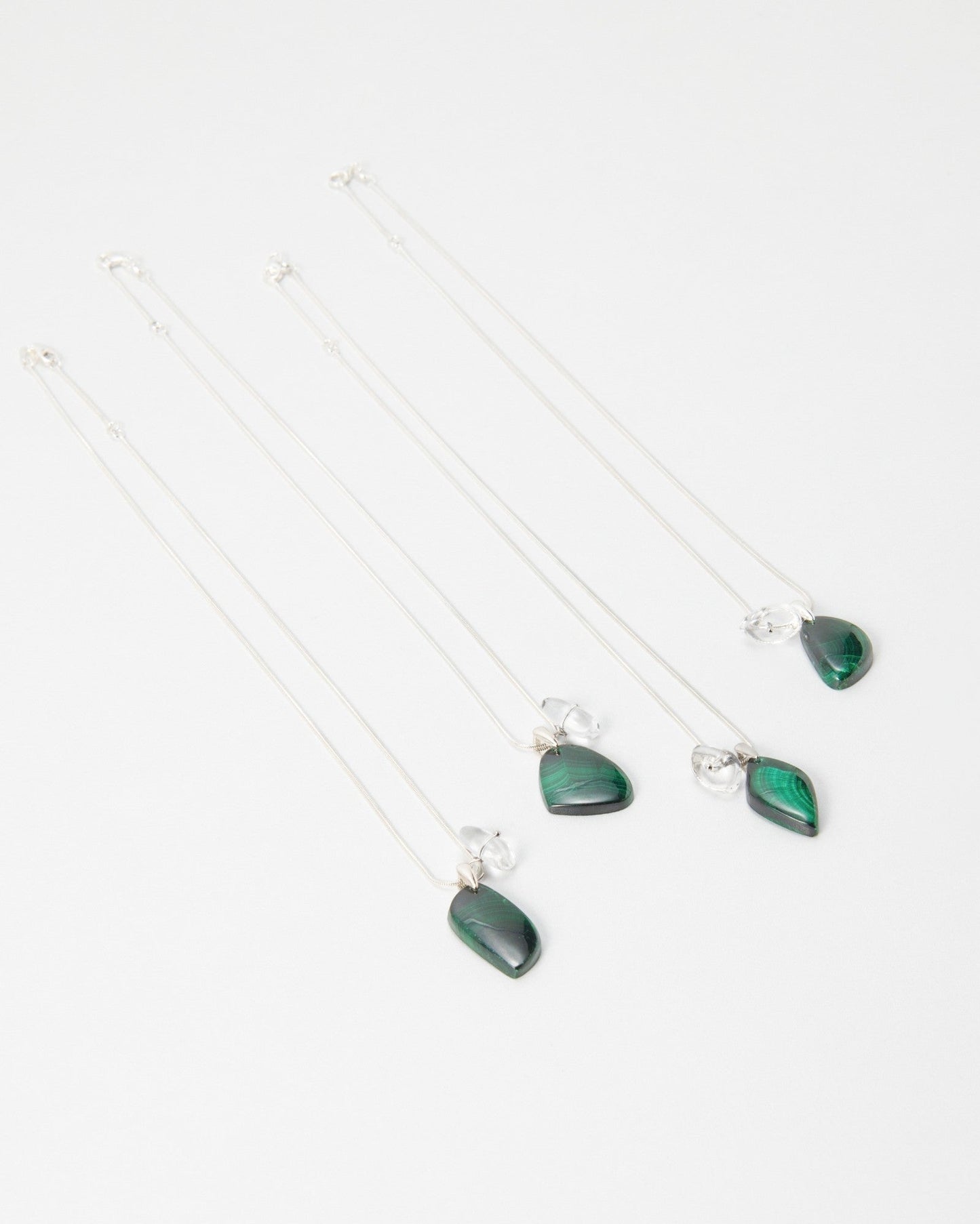 Elsita Jewelry Midnight necklaces featuring polished green malachite teardrop pendants on delicate silver chains.