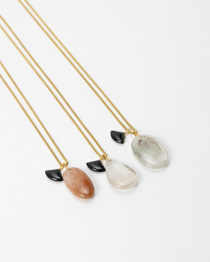 Elsita Jewelry Mist I necklaces featuring gold chains, smooth gemstone pendants, and small black accent charms.