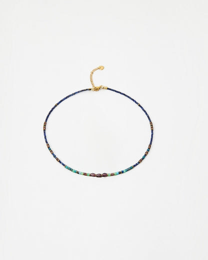 Elsita Jewelry Nomad beaded choker necklace with blue, turquoise, and metallic accents on a gold-tone chain.