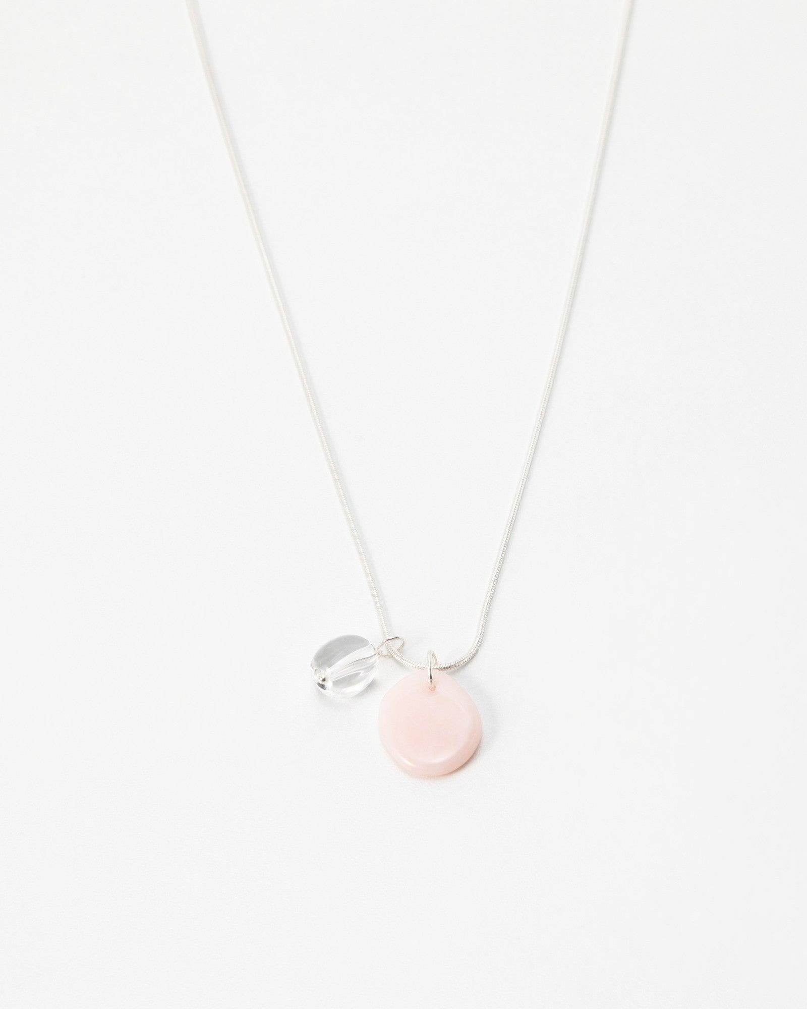 Elsita Jewelry Petal Clear necklace featuring a delicate silver chain with a soft pink disc and clear crystal charm.
