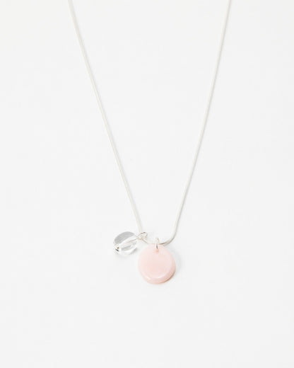 Elsita Jewelry Petal Clear necklace featuring a delicate silver chain with a soft pink disc and clear crystal charm.
