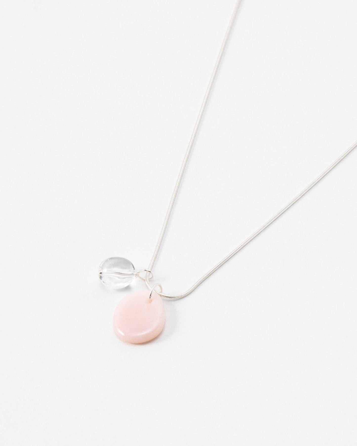 Elsita Jewelry Petal Clear necklace featuring a delicate silver chain with a pink petal charm and clear bead accent.