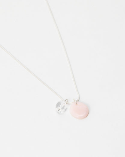 Elsita Jewelry Petal Clear necklace featuring a delicate silver chain with a pink disc and clear crystal charm