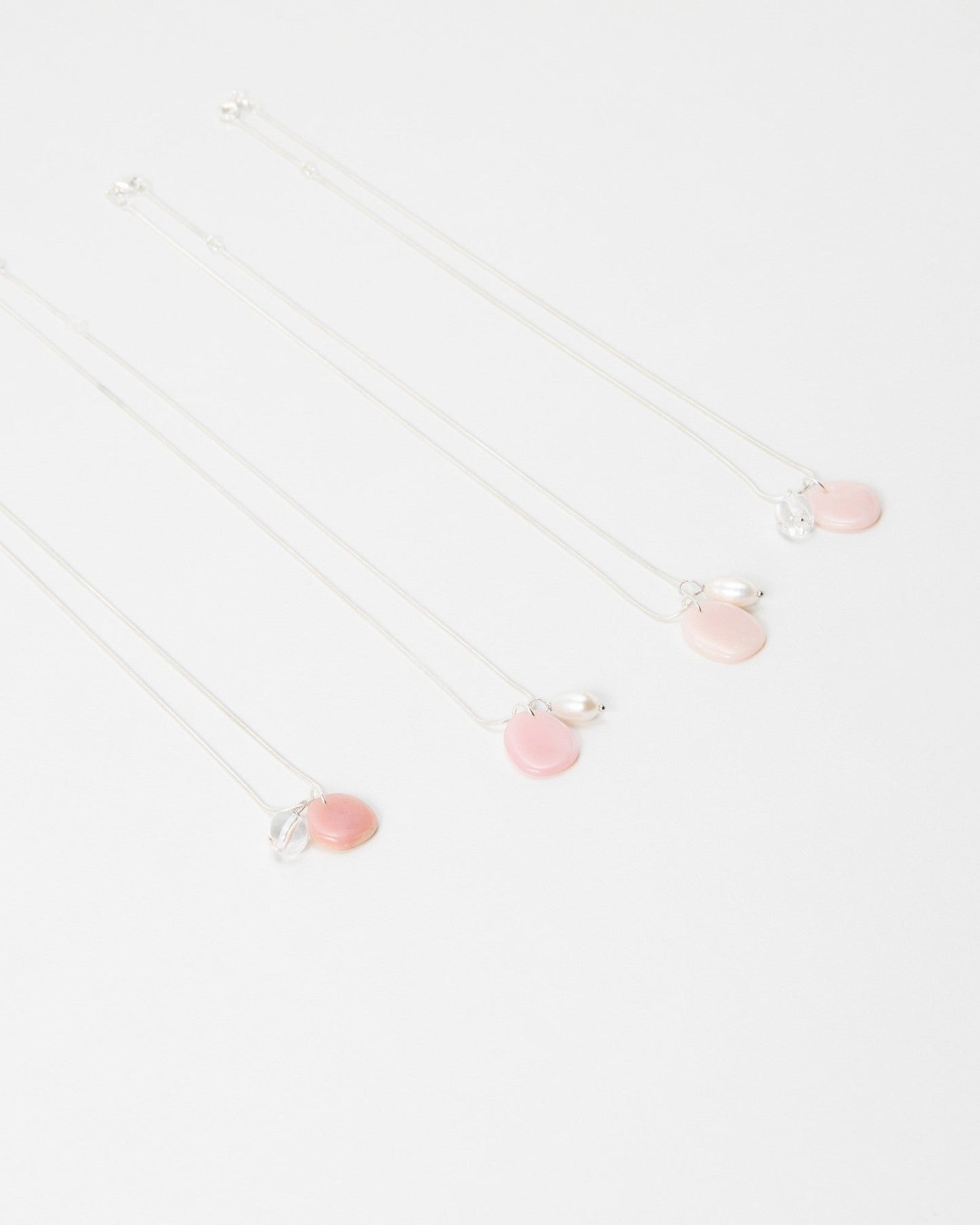 Elsita Jewelry Petal Clear necklaces featuring delicate pink petal charms and clear accents on silver chains