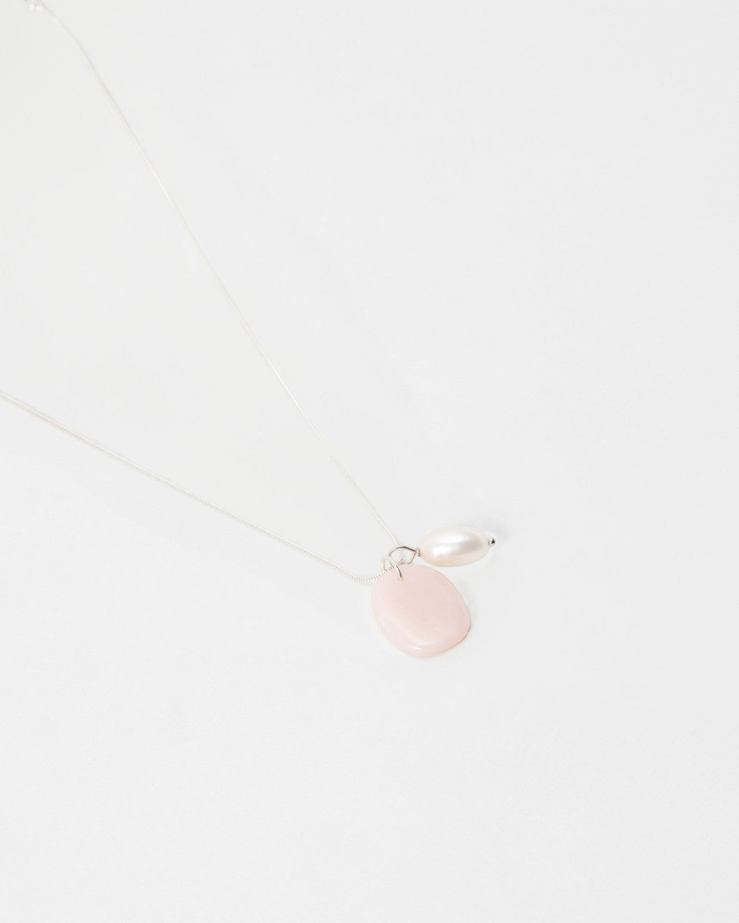 Elsita Jewelry Petal Pearl necklace featuring a delicate silver chain with a pink stone and white pearl pendant