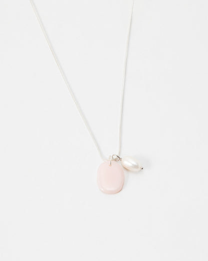 Elsita Jewelry Petal Pearl necklace featuring a delicate silver chain with a pink stone and white pearl charm.