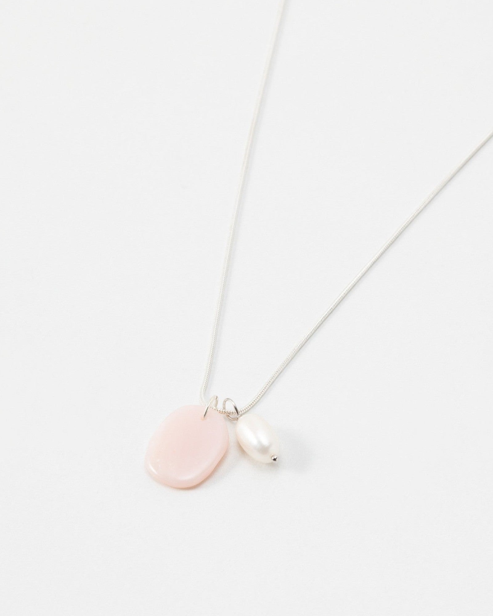 Elsita Jewelry Petal Pearl necklace featuring a delicate silver chain with a pink stone and white pearl pendant