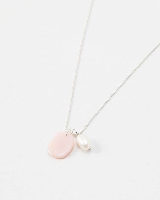 Elsita Jewelry Petal Pearl necklace featuring a delicate silver chain with a pink stone and white pearl pendant