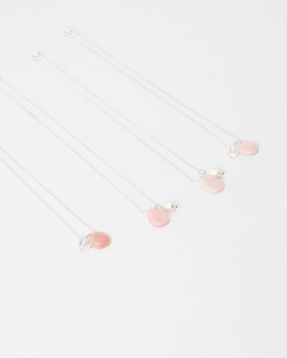 Elsita Jewelry Petal Pearl necklaces featuring delicate pink stone charms and small white pearls on silver chains.