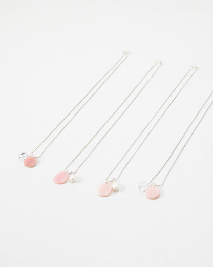 Elsita Jewelry Petal Pearl necklaces featuring delicate pink charms and small white pearls on silver chains.