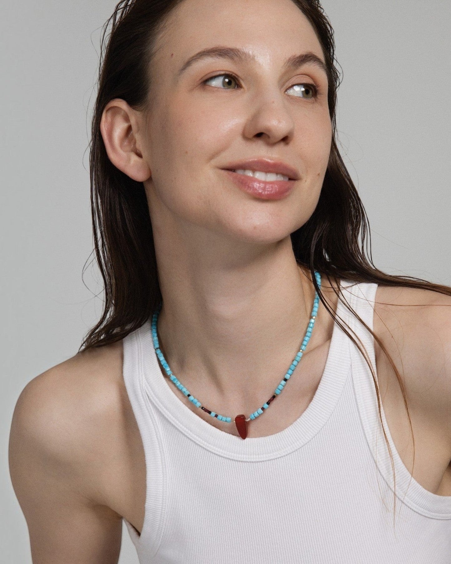 Model wearing Elsita Jewelry Pixel necklace with turquoise, red agate, garnet, black spinel, and sterling silver beads.
