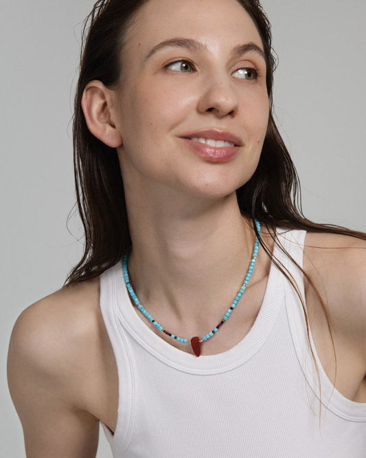 Model wearing Elsita Jewelry Pixel necklace with turquoise, red agate, garnet, black spinel, and sterling silver beads.
