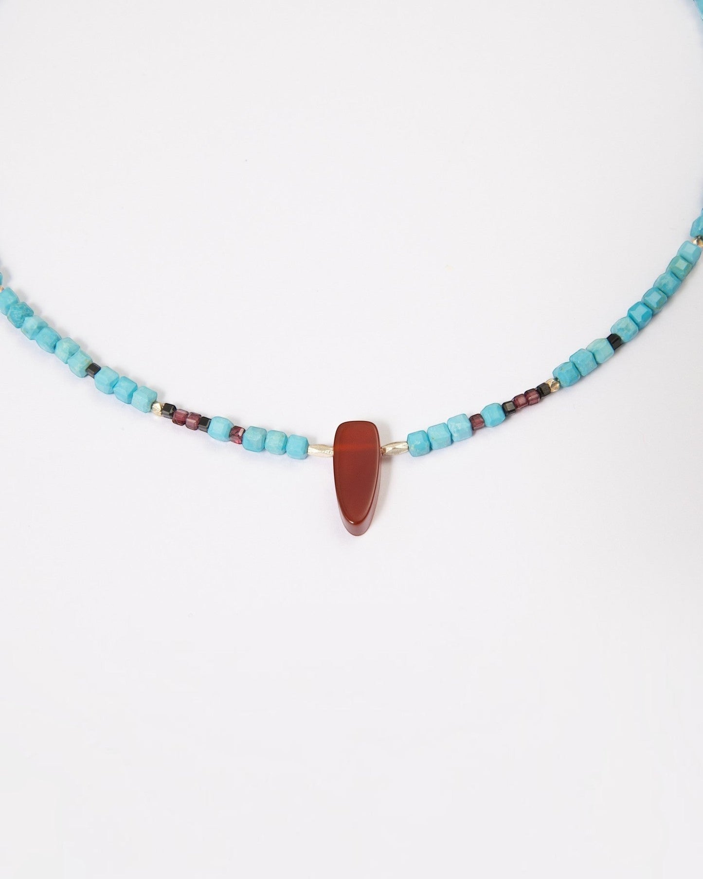 Elsita Jewelry Pixel necklace featuring turquoise cubes, a red agate pendant, garnet, black spinel, and silver beads.