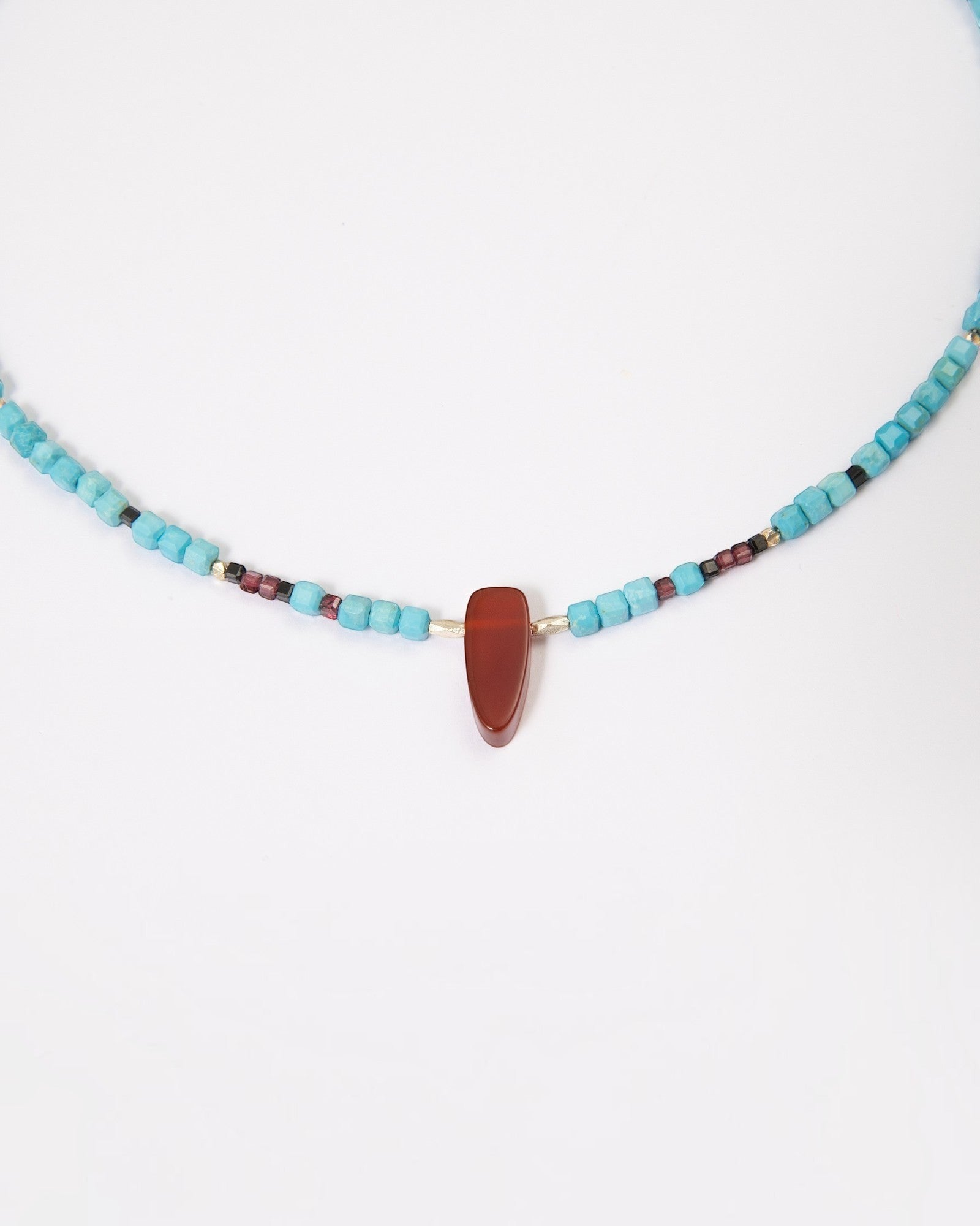 Elsita Jewelry Pixel necklace featuring turquoise cubes, a red agate pendant, garnet, black spinel, and silver beads.