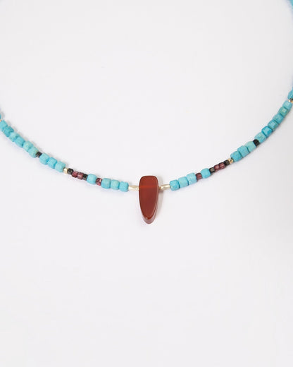 Elsita Jewelry Pixel necklace featuring turquoise cubes, a red agate pendant, garnet, black spinel, and silver beads.